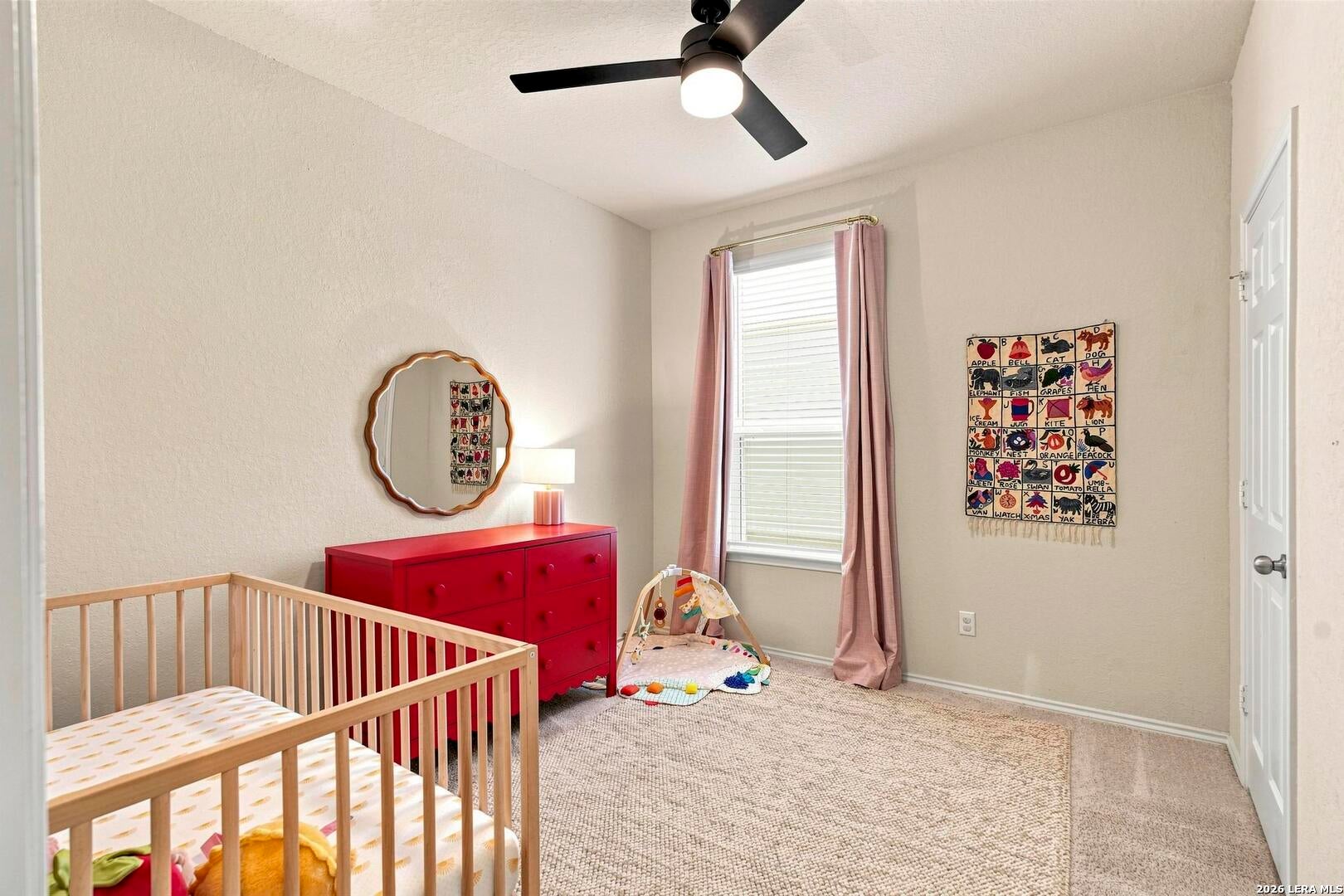 Secondary bedroom with window and closet